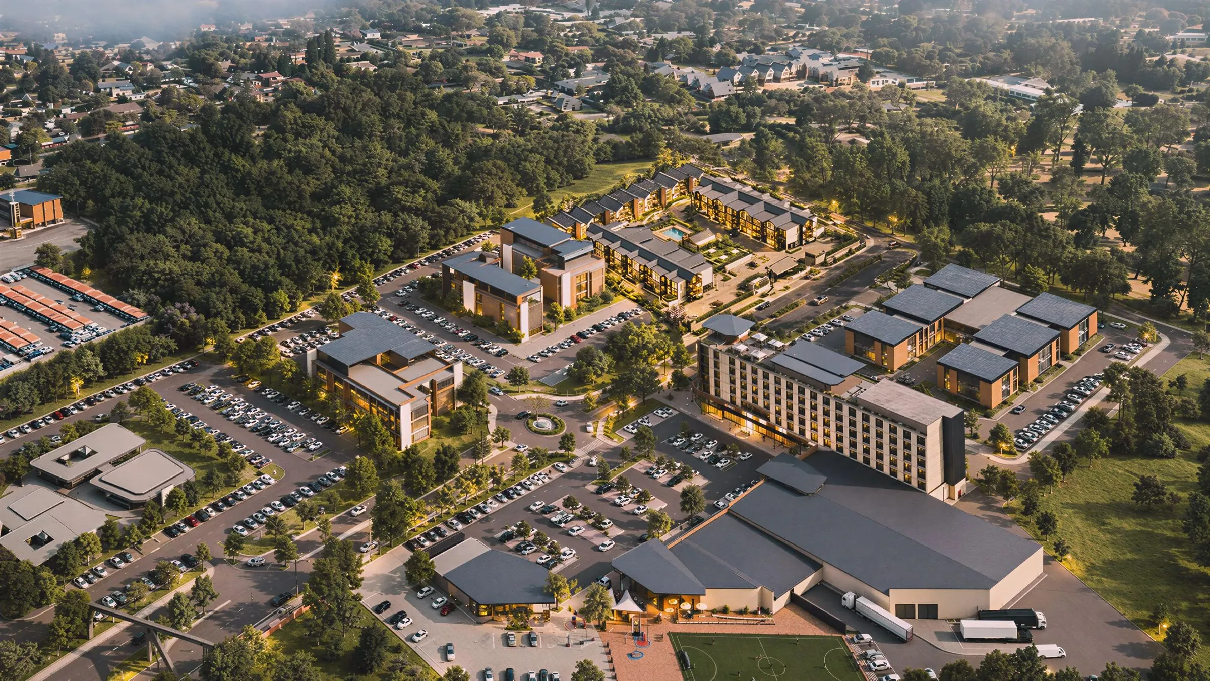 Evening aerial render of the wider Eastpark development, with the residential precinct set against a wooded edge behind the hotel and retail buildings